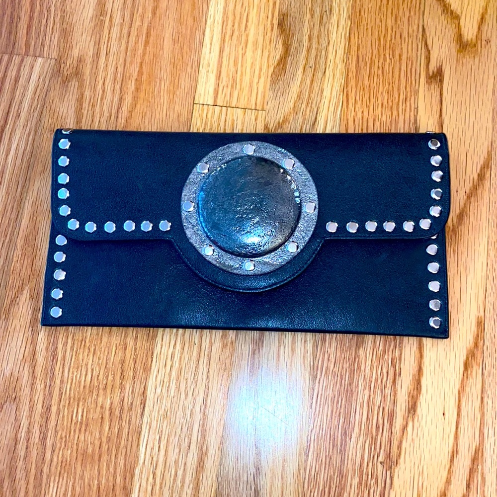 Small black clutch purse. By Carlos Falchi.